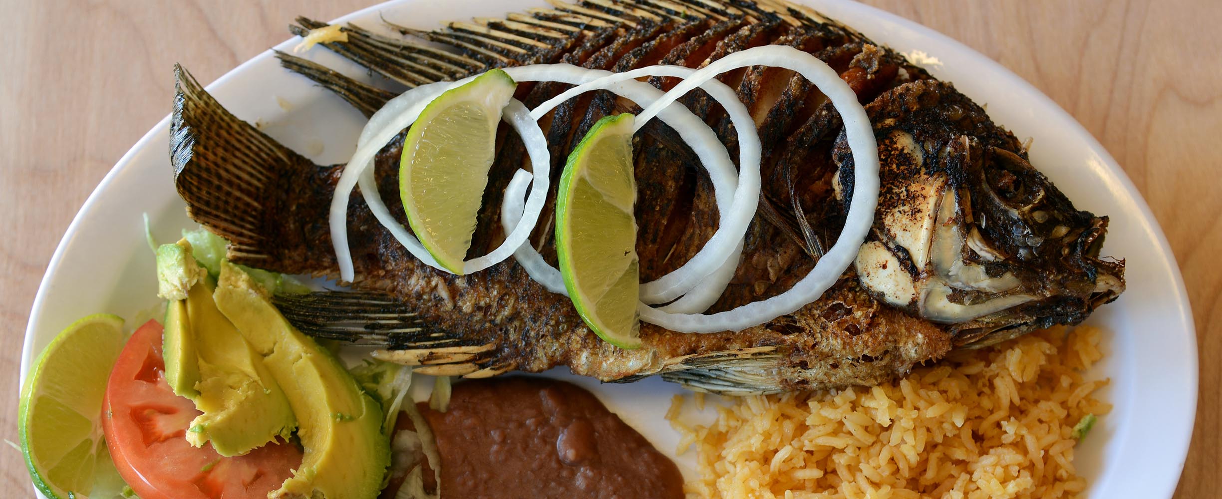 Whole Fried Fish is a Salvadoran dish served in Rincon Sabroso, prepared by Central American cooks